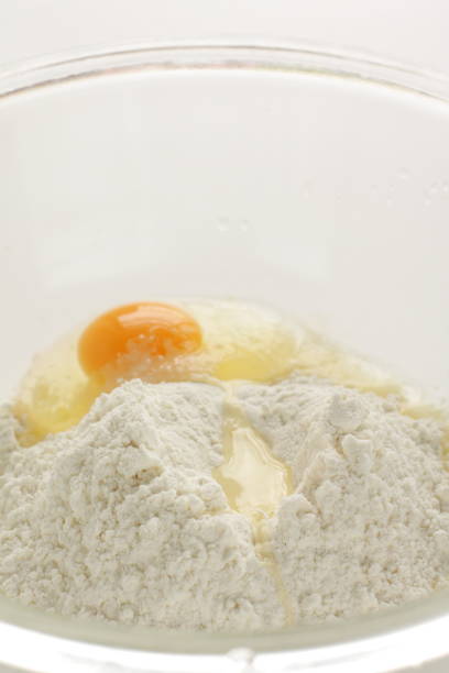 istock raw egg and flour in bowl 1217578238