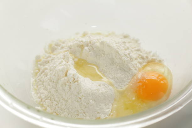 istock raw egg and flour in bowl 1217578243