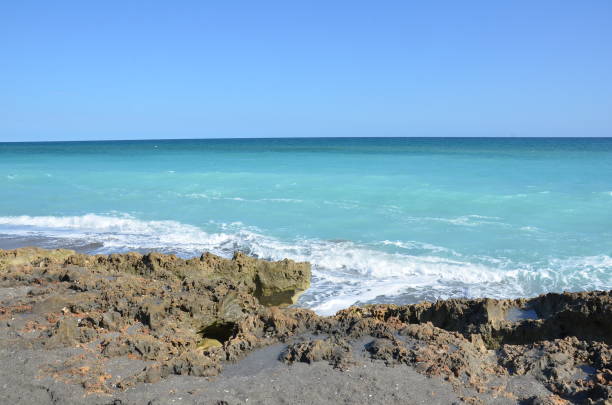 istock rocks and water and waves at beach 1217578308