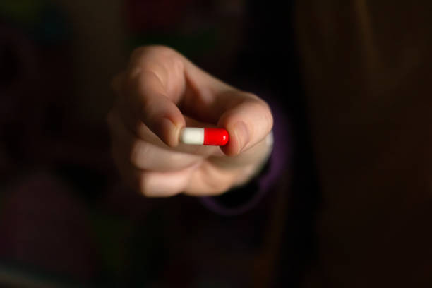 A close-up shot showcases three herbal supplement capsules on a textured off-white surface. The composition emphasizes detail and texture, offering a clear visual representation of natural medicine and dietary supplements. The warm lighting enhances the earthy tones of the capsule contents.