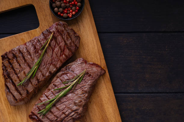 istock Two grilled beef steak on cutting board 1217579591