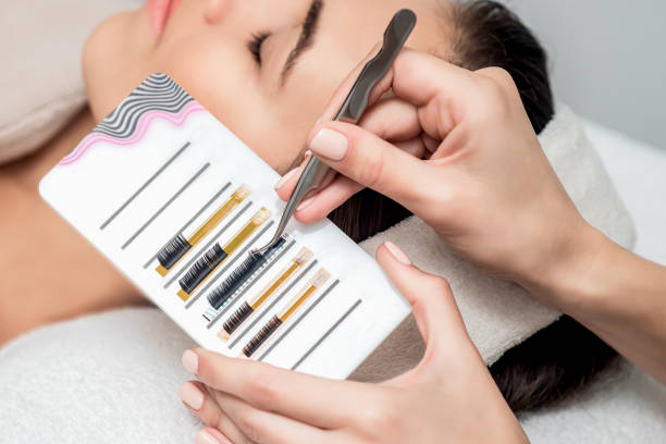 istock Beautician takes eyelashes by tweezers. 1217581237