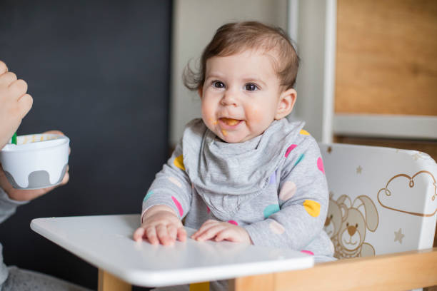 istock Mother feeds baby from spoon 1217583931