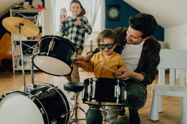 istock Dad and his boys playing drums together 1217584216