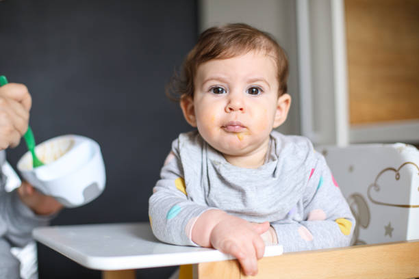 istock Mother feeds baby from spoon 1217584845