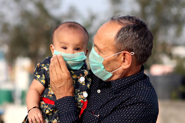 portrait of grandfather and grandchild with pollution mask against covid-19 - babies and children close up horizontal looking at camera imagens e fotografias de stock