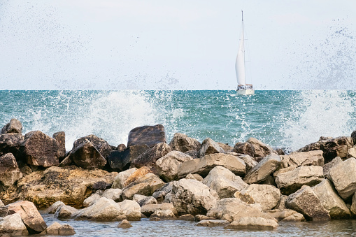 Breakwall in the path of a sailboat on Lake Michigan
