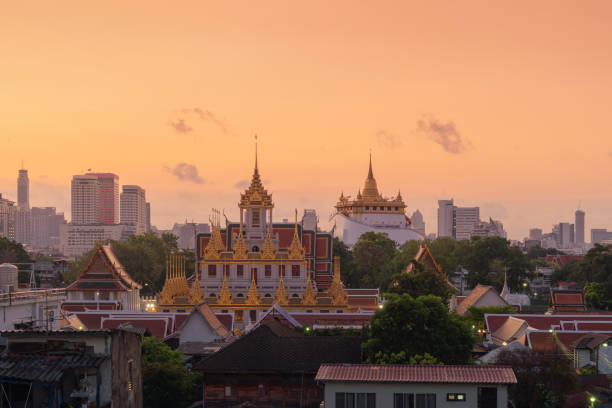 istock Loha Prasat Wat Ratchanatda and Golden Mountain pagoda, a buddhist temple or Wat Saket with skyscraper buildings in Bangkok Downtown, urban city at sunset, Thailand. Thai Landmark. Architecture. 1217588637