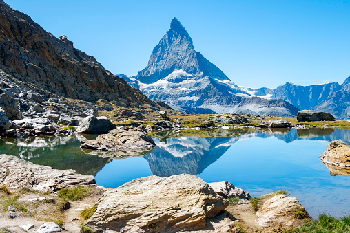 picturesque landscape with wild nature and glacial lake in the Pennine Alps, in the background peak Matterhorn, canton of Valais, Switzerland