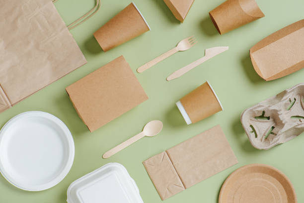 istock Eco-friendly disposable dishware and bamboo utensils over green background 1217588853