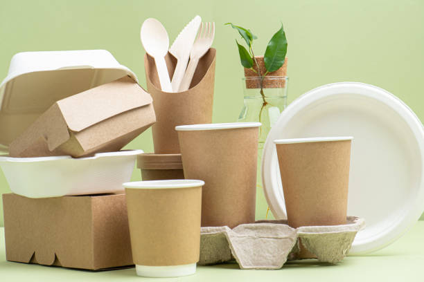 istock Side view on eco-friendly disposable containers for food and drinks over green 1217588955