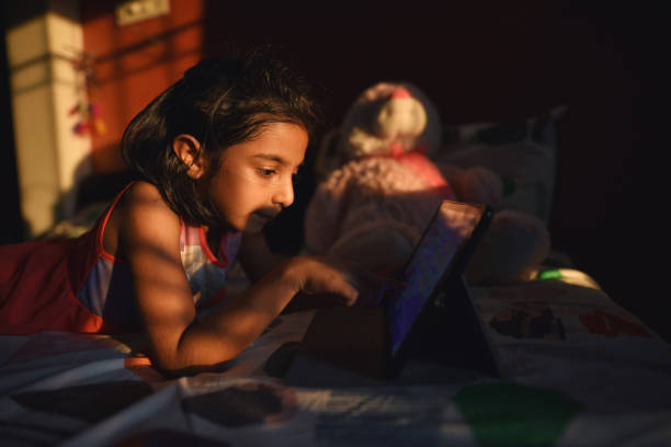 istock Girl watching educational video Lying on the bed 1217589393
