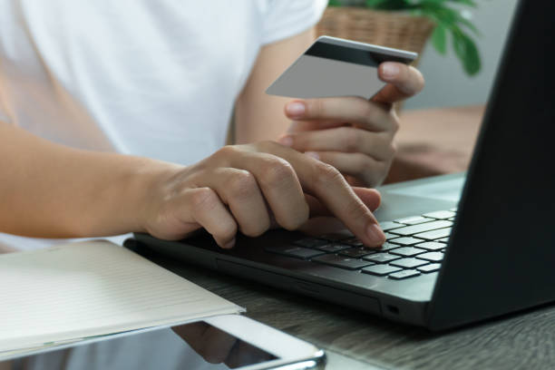 istock Hands holding credit card and using laptop. Online shopping. work from home concept 1217590292