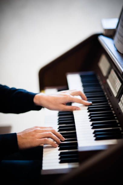 istock pianist plays electric keyboard piano close up on hands 1217590777