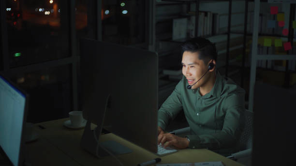 istock Asia Business man using computer for customer care working overtime at night 1217592215