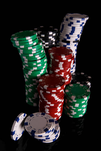 istock Isolated casino tokens on black background 1217593901