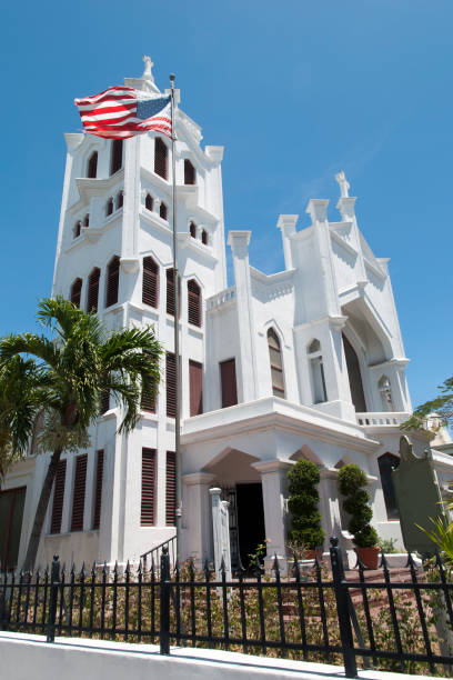 The historic 19th century St. Paul's Episcopal Church and the flag in Key West downtown (Florida).
