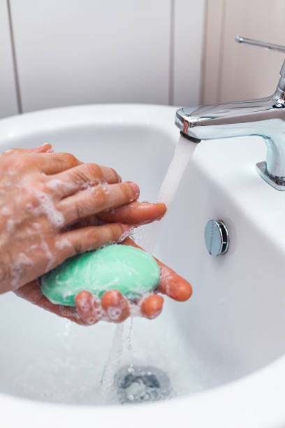 istock A man washes his hands with soap in the sink 1217596681