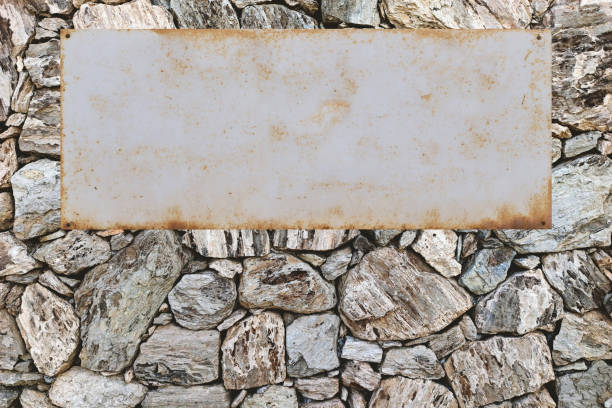 istock Natural stone wall with metal shield, copy space 1217596785