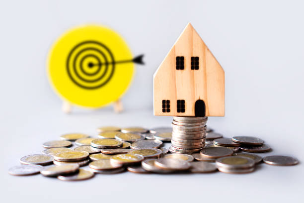 istock buying home,retirement and saving plan concept with house model and  target in background 1217598791