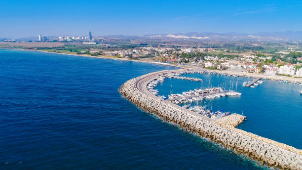 Aerial Zygi, Larnaca Aerial bird's eye view of Zygi fishing village port, Larnaca, Cyprus. The fish boats moored in the harbour with docked yachts and skyline of the town near Limassol from above. limassol marina stock pictures, royalty-free photos & images