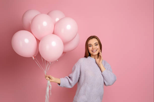 istock birthday girl posing with balloons 1217602687