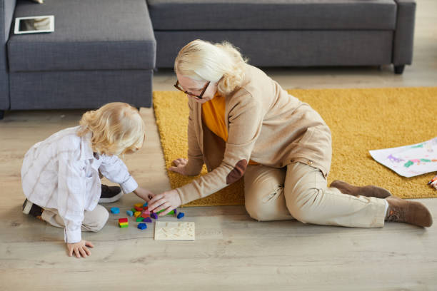 istock Grandmother playing with little boy 1217603733