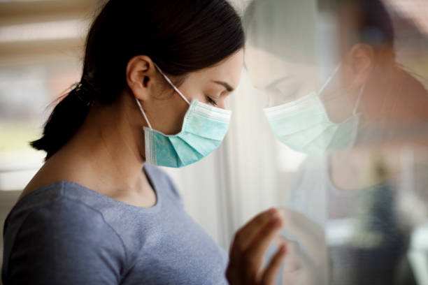 portrait of sad young woman with face protective mask at hospital - mental health depression illness healthy lifestyle imagens e fotografias de stock
