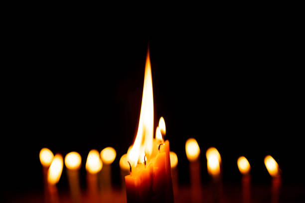 istock candles and lights  on a black background with boken lights. 1217605403