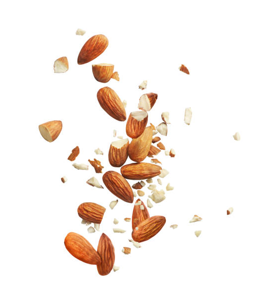 whole and crushed almonds on a white background whole and crushed almonds on a white background almond slivers stock pictures, royalty-free photos & images
