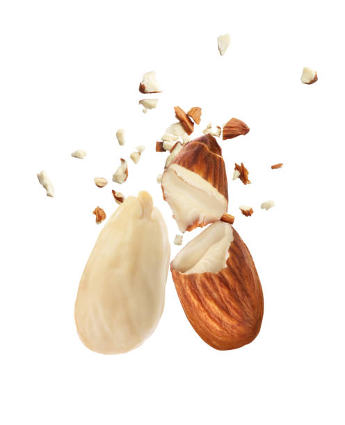 Almonds fragmented on a white background. Peeled almonds. Almonds fragmented on a white background. Peeled almonds. almond slivers stock pictures, royalty-free photos & images