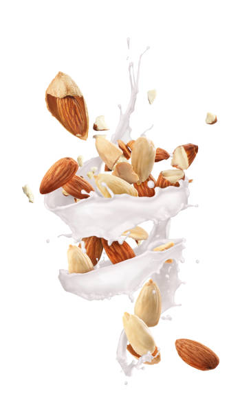 istock Whirlwind of milk with almonds on a white background 1217607113
