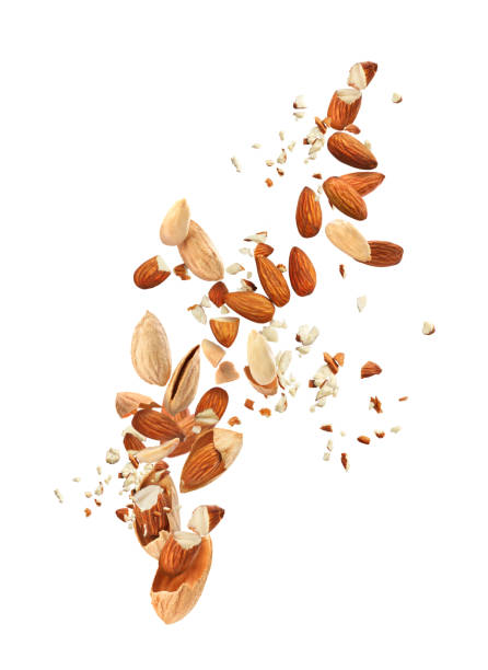 A lot of almonds on a white background. Crushed almonds A lot of almonds on a white background. Crushed almonds crunchy photos stock pictures, royalty-free photos & images