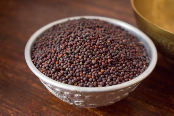 istock Mustard seeds in a Silver bowl on wooden old Table. Rustic Style 1217607494