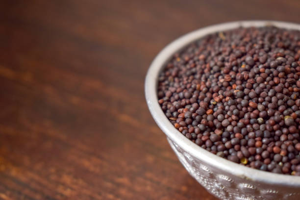 istock Mustard seeds in a Silver bowl on wooden old Table. Rustic Style 1217607565