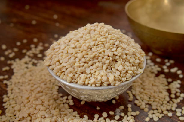 istock Split White Urad Dal. Vigna mungo Beans  in a Silver bowl on wooden old Table. Rustic style 1217607672