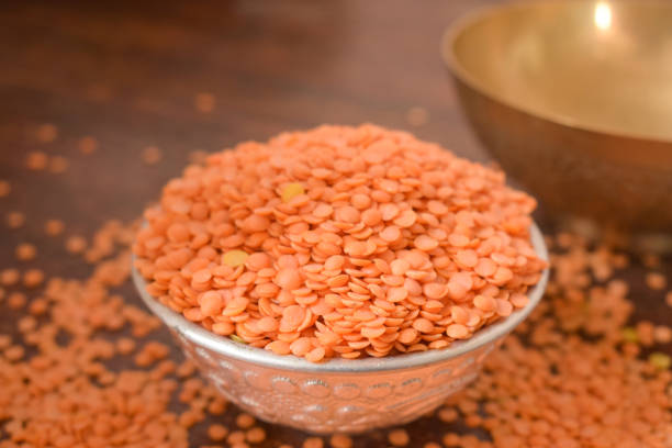 istock Dry Split Red Lentils in a Silver bowl on wooden old Table. rustic style 1217607901