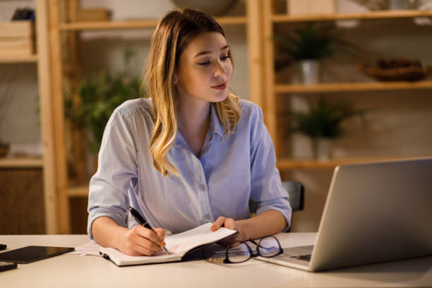 istock Young woman doing finances at home using laptop 1217607923