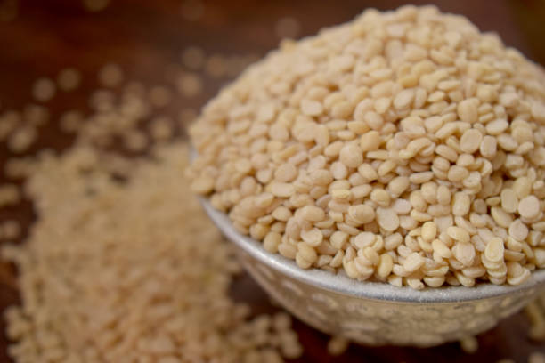 istock Split White Urad Dal. Vigna mungo Beans  in a Silver bowl on wooden old Table. Rustic style 1217608070