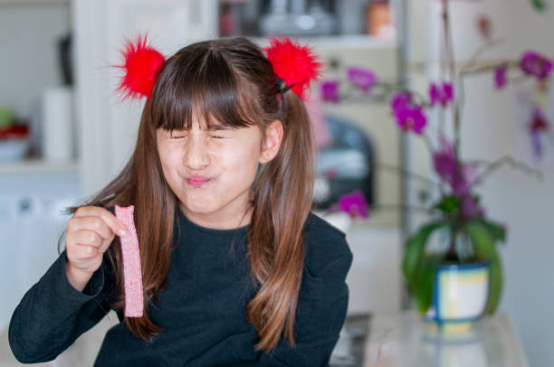 Turkish Cute girl looking to  candy sour sugar