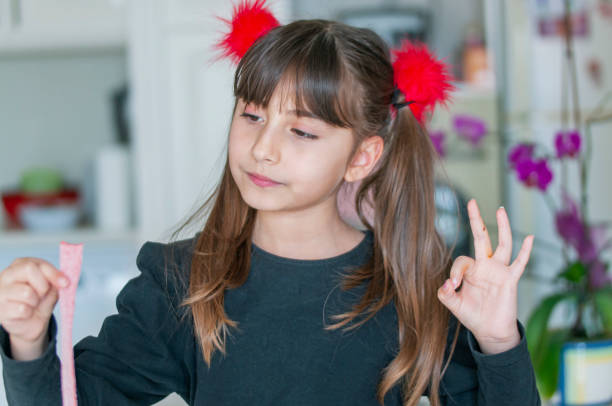 istock Cute girl eating  candy sweet sugar 1217611044