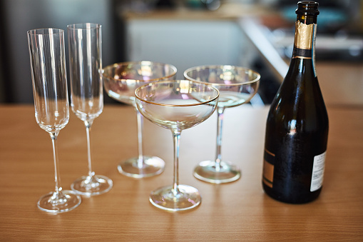 Still life shot of glasses and bottle of champagne on a table