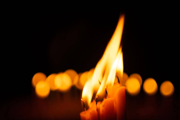candles and lights  on a black background with bokeh lights.