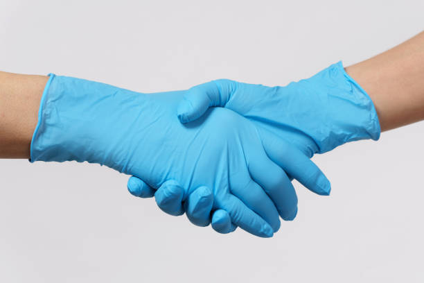 istock People wearing latex gloves greeting each other 1217614963