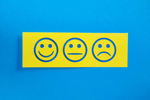 Yellow Sticky Paper With Customer Satisfaction Smily Face On Blue Background Yellow Sticky Paper With Customer Satisfaction Smily Face On Blue Background. Horizontal composition with copy space. smiley face postit stock pictures, royalty-free photos & images