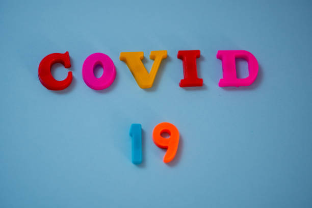istock Covid 19 text against isolated background 1217615312