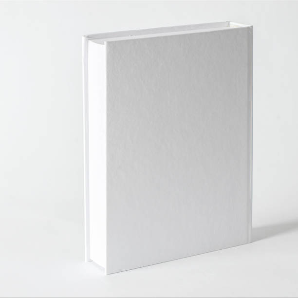 istock Mockup of closed blank square book at white textured paper background 1217618791