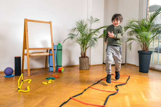 istock Boy Jumping Over Ladders Indoors 1217620210