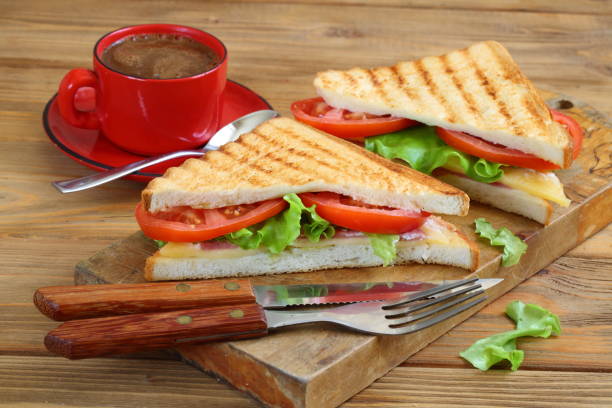 istock Sandwich with tomatoes, cheese and ham on a dark, wooden background 1217621602