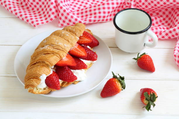 Croissant with strawberries stock photo